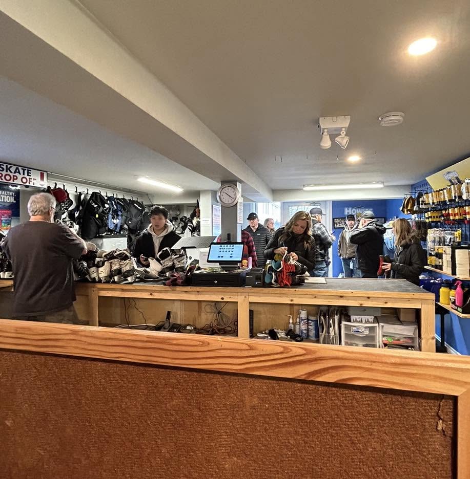 Customers and staff gathered around the counter inside Skate Tech